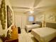 Bright bedroom featuring two twin beds, ceiling fan, closet, and neutral decor at 167 Scottsdale Sq # 167, Winter Park, FL 32792
