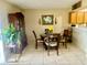 Inviting dining room featuring a round table with four chairs, a hutch, and tile flooring at 167 Scottsdale Sq # 167, Winter Park, FL 32792