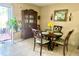 Well-lit dining room with a round table, china cabinet, and sliding doors to a balcony at 167 Scottsdale Sq # 167, Winter Park, FL 32792