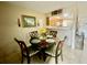 Inviting dining area leading to the kitchen, featuring a round table with four chairs at 167 Scottsdale Sq # 167, Winter Park, FL 32792