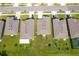 Overhead shot of homes, grassy lawns, and trees in a community, highlighted with a red boundary at 1959 Cricket Cradle Dr, Kissimmee, FL 34746