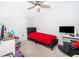 Cozy bedroom with a ceiling fan and a window for natural light at 1959 Cricket Cradle Dr, Kissimmee, FL 34746