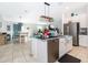 Open-concept kitchen featuring stainless steel appliances and a center island at 1959 Cricket Cradle Dr, Kissimmee, FL 34746