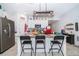 Modern kitchen island with barstool seating, stainless steel appliances and white cabinets at 1959 Cricket Cradle Dr, Kissimmee, FL 34746