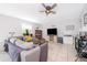 Comfortable living room featuring tile floors, a ceiling fan and a gray couch at 1959 Cricket Cradle Dr, Kissimmee, FL 34746