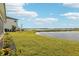 A gorgeous backyard view of a lake with manicured lawn and landscaping next to the lake at 224 Valencia Ridge Dr, Auburndale, FL 33823