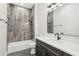 Bathroom features a vanity with dark wood cabinets, bright lighting and a shower tub combo at 224 Valencia Ridge Dr, Auburndale, FL 33823