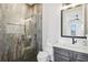 Bathroom featuring tiled walk-in shower, modern vanity, and dark fixtures at 224 Valencia Ridge Dr, Auburndale, FL 33823