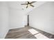 Bedroom featuring wood-look flooring, a ceiling fan and access to other rooms at 224 Valencia Ridge Dr, Auburndale, FL 33823