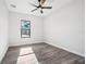Bedroom with wood-look flooring, a ceiling fan and a window with neighborhood views at 224 Valencia Ridge Dr, Auburndale, FL 33823