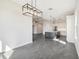 Open-concept dining area with view of kitchen, featuring modern chandelier and tile flooring at 224 Valencia Ridge Dr, Auburndale, FL 33823