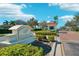Welcoming Water Ridge community entrance with manicured landscaping and a guardhouse at 224 Valencia Ridge Dr, Auburndale, FL 33823