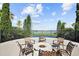 An outdoor fire pit overlooks a tranquil lake at 224 Valencia Ridge Dr, Auburndale, FL 33823