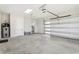 Spacious three car garage with high ceilings, and white walls at 224 Valencia Ridge Dr, Auburndale, FL 33823