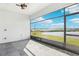 Enclosed lanai offering scenic views of the backyard and a tranquil lake at 224 Valencia Ridge Dr, Auburndale, FL 33823