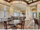 Spacious clubhouse area with a dining table, bar seating, and kitchen in the background at 224 Valencia Ridge Dr, Auburndale, FL 33823