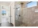 Luxurious shower with frameless glass enclosure and stone accents at 224 Valencia Ridge Dr, Auburndale, FL 33823