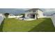 Spacious backyard with a modern pool, lush lawn, and white privacy fence at 2508 W End Dr, St Cloud, FL 34772