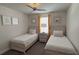 Comfortable bedroom with twin beds, decorative pillows, ceiling fan, and coordinated decor at 2508 W End Dr, St Cloud, FL 34772