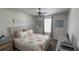 Bright bedroom with a queen bed, neutral decor, and soft natural light filtering through the window at 2508 W End Dr, St Cloud, FL 34772