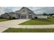 A two-story house with a light gray exterior, attached two-car garage, and a well-maintained green lawn at 2508 W End Dr, St Cloud, FL 34772