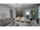 Open concept living room featuring modern lighting, neutral furniture, and seamless access to the kitchen at 2508 W End Dr, St Cloud, FL 34772