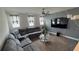 Comfortable living room with a large sectional sofa, modern ceiling fan, and a decorative accent wall at 2508 W End Dr, St Cloud, FL 34772
