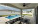 Relaxing backyard oasis with a sparkling pool, comfortable seating, and string lights at 2508 W End Dr, St Cloud, FL 34772