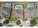 Overhead view of homes featuring screened-in pools and well-maintained lawns in a suburban neighborhood at 256 Yellow Snapdragon Dr, Davenport, FL 33837