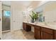 Bright bathroom with a double vanity, large mirror, walk-in shower, and neutral tones throughout at 256 Yellow Snapdragon Dr, Davenport, FL 33837