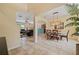 An open-concept dining room leads into the living room and kitchen with tile floors and stylish chandelier lighting at 256 Yellow Snapdragon Dr, Davenport, FL 33837
