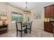 Bright dining room with modern chandelier and sliding glass door to screened patio and pool at 256 Yellow Snapdragon Dr, Davenport, FL 33837
