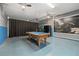 Entertainment room features a blue pool table, a projector and screen, and a fun Star Wars themed mural on the wall at 256 Yellow Snapdragon Dr, Davenport, FL 33837