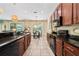 Updated kitchen boasts wood cabinets, granite counters, black appliances, and an eat-in dining area at 256 Yellow Snapdragon Dr, Davenport, FL 33837