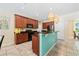 Open kitchen features granite countertops, wood cabinets, stainless steel appliances and breakfast bar at 256 Yellow Snapdragon Dr, Davenport, FL 33837