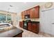 Kitchen features dark wood cabinets, granite countertops, black appliances, and a view into the dining room at 256 Yellow Snapdragon Dr, Davenport, FL 33837