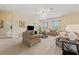 Spacious living room featuring neutral colors, comfortable seating, and a ceiling fan at 256 Yellow Snapdragon Dr, Davenport, FL 33837