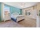 Bright main bedroom showcasing a white poster bed with beautiful decor and two large windows at 256 Yellow Snapdragon Dr, Davenport, FL 33837