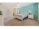 Bright main bedroom showcasing a white poster bed with beautiful decor and a large window overlooking the outdoors at 256 Yellow Snapdragon Dr, Davenport, FL 33837
