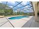 View of screened in pool and landscaping with hot tub at 256 Yellow Snapdragon Dr, Davenport, FL 33837