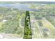 An aerial view of a lot showing its boundaries and surroundings including trees and a lake in the background at 2571 Ames Haven Rd, Kissimmee, FL 34744