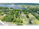 An aerial view of a property located on a tree-lined street with a lake in the background at 2571 Ames Haven Rd, Kissimmee, FL 34744