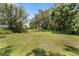 Expansive backyard featuring a well-maintained lawn and mature trees, offering a serene outdoor space at 2571 Ames Haven Rd, Kissimmee, FL 34744