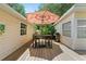 Cozy outdoor deck area featuring a dining table, umbrella, and grill, perfect for al fresco dining at 2571 Ames Haven Rd, Kissimmee, FL 34744