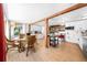 Bright dining area with hardwood floors, wooden beams, and an adjacent modern kitchen perfect for Gathering meals at 2571 Ames Haven Rd, Kissimmee, FL 34744