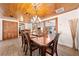 Elegant dining room featuring wood ceiling, flooring and a chandelier creating a warm and inviting atmosphere at 2571 Ames Haven Rd, Kissimmee, FL 34744
