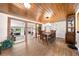 Elegant dining room with a wood ceiling and flooring, and a large decorative clock at 2571 Ames Haven Rd, Kissimmee, FL 34744