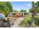 Charming cottage-style home with vibrant red chairs, a quaint sign, and well-manicured landscaping at 2571 Ames Haven Rd, Kissimmee, FL 34744