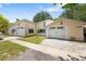 Charming cottage-style home with dual garages, a well-maintained lawn, and lovely curb appeal at 2571 Ames Haven Rd, Kissimmee, FL 34744