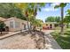 Charming cottage with palm trees, walkway, and inviting entrance, creating a relaxing and tropical curb appeal at 2571 Ames Haven Rd, Kissimmee, FL 34744